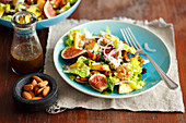 Salad with figs, nectarines, feta, cranberry and almonds plus walnuts fried with honey