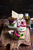 A slice of baguette topped with goat's cheese and beetroot