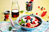 Custard with fresh fruits and fruit syrup