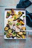 Oven-baked cod fillet with artichokes and courgette