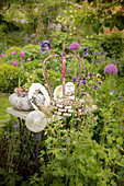 Vintage garden decorations in herbaceous border