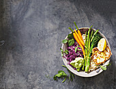 A veggie bowl with spring vegetables and haloumi