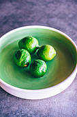 Unripe lemons in a bowl