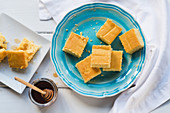Cornbread on a blue plate and honey