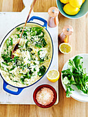 Lemon risotto with spinach leaves in a casserole dish