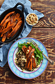 Baked whole carrots served with quinoa and almonds