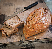 A loaf of rustic bread on a wooden surface