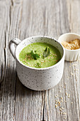 Cold pea and wasabi soup with sesame seeds in a cup