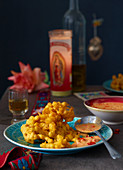 Corn fritters with spicy cheese sauce (Mexico)