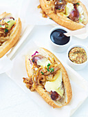 Gourmet hot dogs with braised cider onions