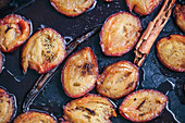 Roasted plums with vanilla and cinnamon in a baking dish