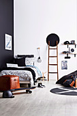 Black and white youth room with ladder and DIY shelf made of skateboards