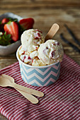 Strawberry and vanilla ice cream in a tub