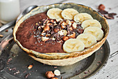 Chocolate smoothie bowl with hazelnuts and bananas