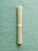 A bundle of rice noodles on a textured background