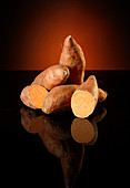 Sweet potatoes against a dark background