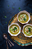 Cauliflower and curry soup with spring onions and chilli flakes