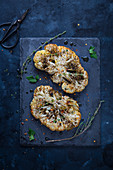 Roasted cauliflower escalopes with herbs (seen from above)