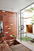 Shower with brick wall and garden access