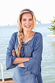 A young blonde woman wearing a denim blouse