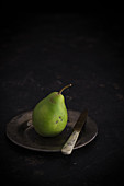 Bürgermeisterbirne (Mayor's pear) on a plate with a knife