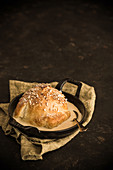 A baked apple with a marzipan, nut and raisin filling in puff pastry in vanilla sauce