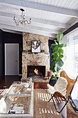 Classic leather chair with a fur blanket and houseplant in front of a fireplace in the living room