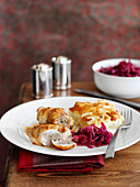 Stuffed chicken drumsticks with potato gratin and red cabbage