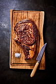 Seared beef steak on a wooden chopping board