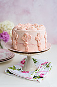 Festive vanilla cake with a pink fondant glaze