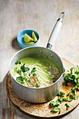 Quick pea soup with coriander, ginger, onion, coconut milk and pepper