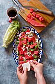 Watermelon lettuce salad with feta cheese and balsamic dressing on a plate