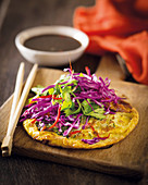 Egg foo young (oriental omelette) with a red cabbage salad