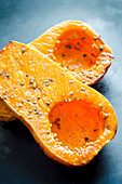 Halved, roasted butternut squash with sesame seeds