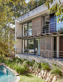 Modern architect-designed house with balconies overlooking garden and pool