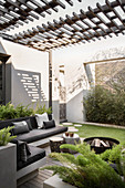 Masonry benches with grey cushions on roofed terrace