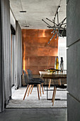 Extravagant dining room in shades of grey with metal-clad wall