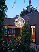 Designer lamp in garden of house with panoramic windows