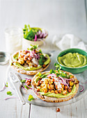 Pita breads with roasted vegetables, chickpeas and avocado cream