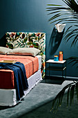 Individual, upholstered headboard, cover with plant motif, on double bed