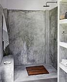 Simple shower with polished cement wall in the garden house