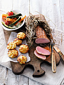 Mangalitza pork fillet wrapped in hay served with potato and parsnip fritters