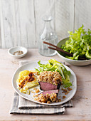 Beef fillet with a walnut crust served with potato gratin and a green salad