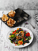 Salad flowers with courgette and cream cheese rolls in puff pastries