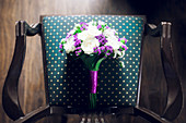 A bouquet of flowers on an armchair