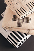 Folded blankets with graphic black and white patterns