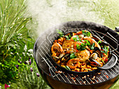 Grilled paella with chicken and seafood