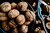 Walnuts in a bowl beside a Nutcracker