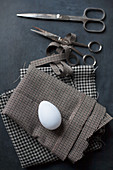 White egg on checked fabric