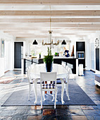 Oval dining table in front of modern open-plan kitchen